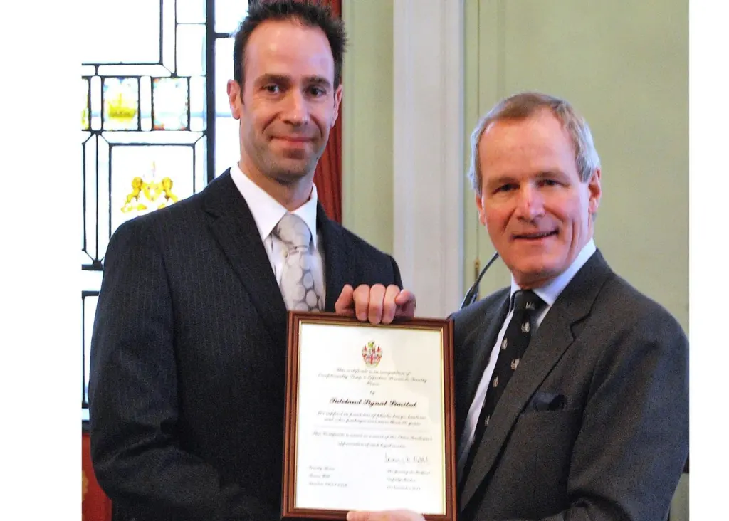Sir Jeremy de Halpert, deputy master of Trinity House presents Chris Smith, systems engineer at Tideland Signal, with the special award.