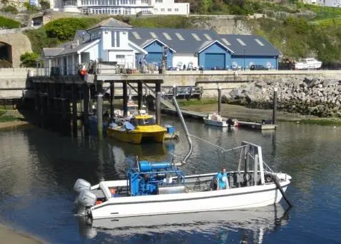 The Cheetah Mini Dredge is seen undergoing trials in front of the builder’s Ventnor Haven base and build facility.
