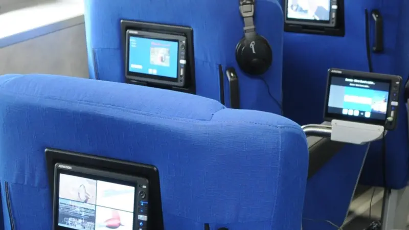 A central server distributes on demand multimedia, such as movies, music and infotainment directly to touch panels for each passenger seat.