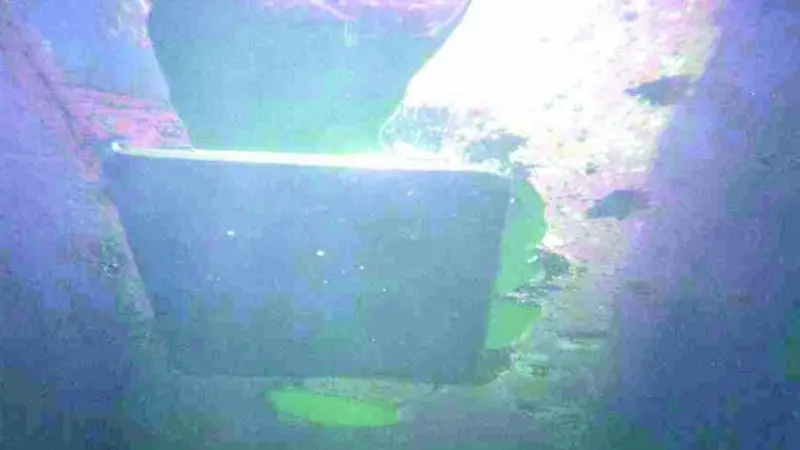 The plate is seen after being successfully overhead welded into position.