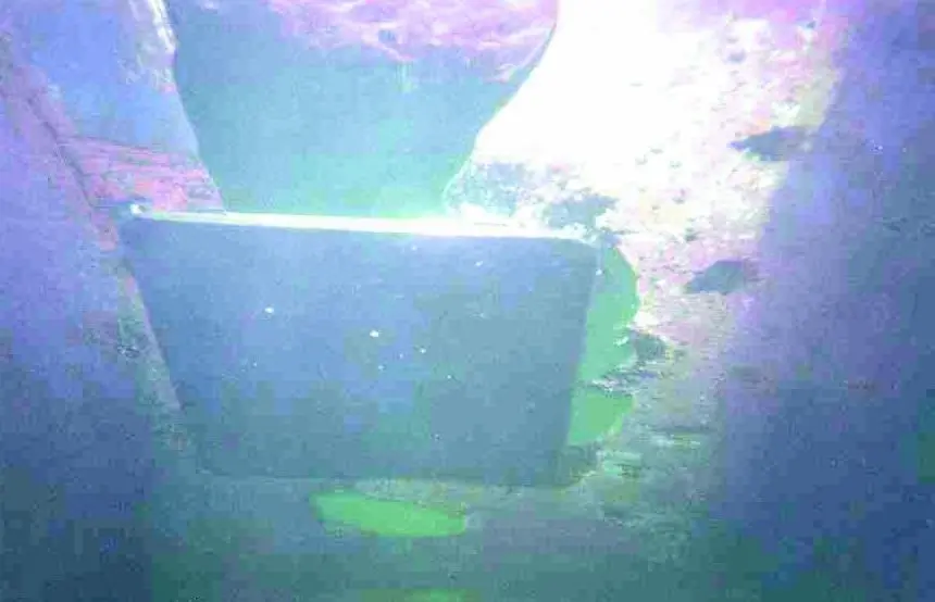 The plate is seen after being successfully overhead welded into position.