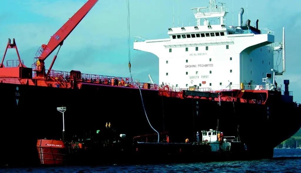 The specially adapted barge Falmouth Jubilee extracts oil slops from the tanker Tikhoretsk.