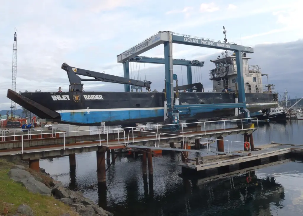 The workboat Inlet Raider gets a lift from the new hoist.