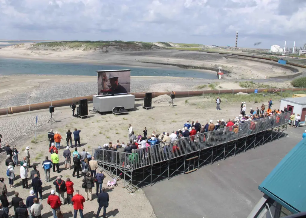 Visitors to FutureLand at Maasvlakte 2 watch live television coverage of the closure. Photo: Peter Barker