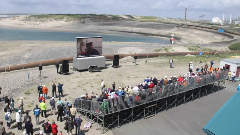 Visitors to FutureLand at Maasvlakte 2 watch live television coverage of the closure. Photo: Peter Barker