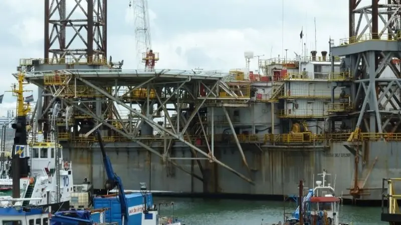Demolition work started with removing the derricks and drilling installation
