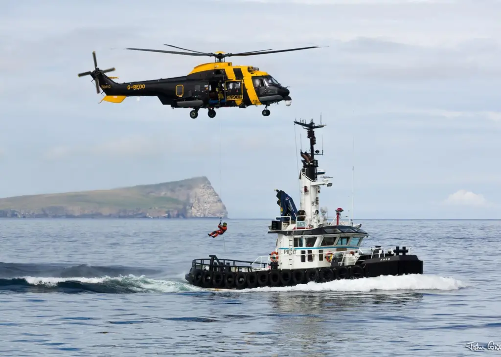 The Bong Jigsaw search and rescue helicopter carryong out winching on exercise with the Lerwick Authority pilot boat, 'Knab'