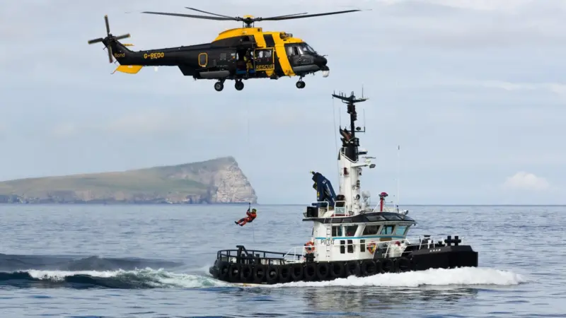 The Bong Jigsaw search and rescue helicopter carryong out winching on exercise with the Lerwick Authority pilot boat, 'Knab'