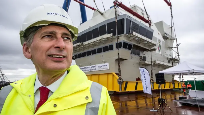 The QE Class carrier’s forward island lift was witnessed by UK Defence Secretary Philip Hammond
