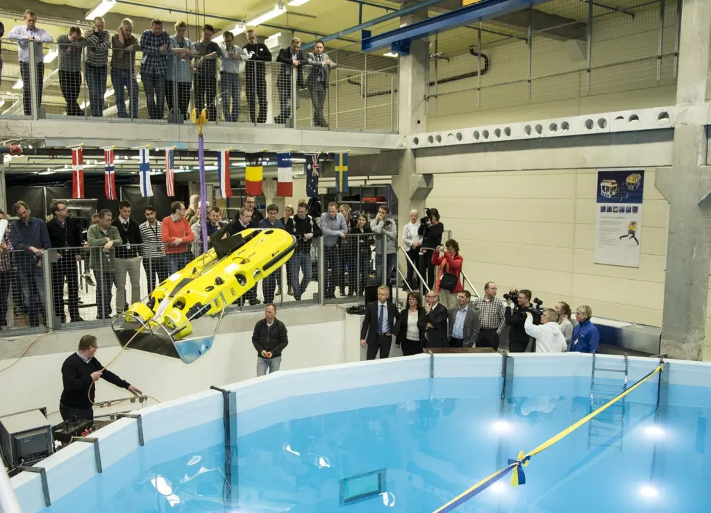 An underwater vehicle is lowered into the new test tank in preparation for opening ceremony