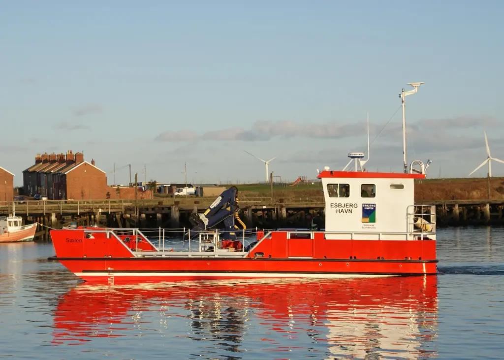 One of the many workboats throughout Europe fitted with a crane supplied by Outreach Ltd