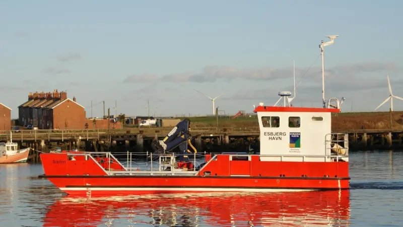One of the many workboats throughout Europe fitted with a crane supplied by Outreach Ltd