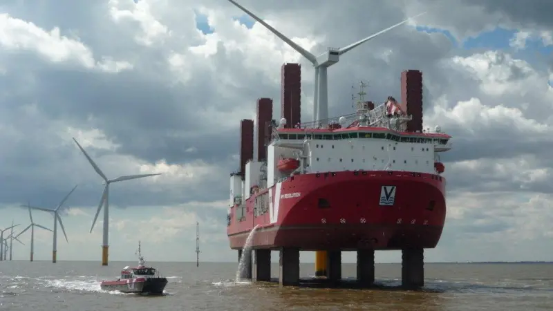 An MPI windfarm service vessel manoeuvres close to a jack-up wind turbine installation ship