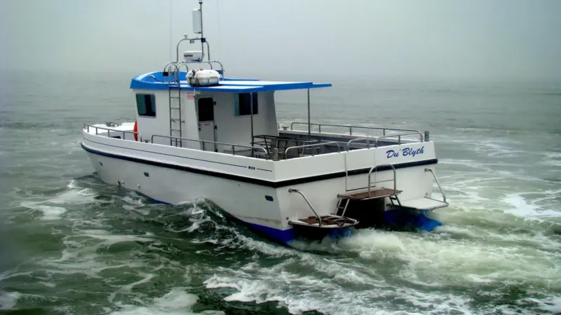 The Dive Blyth Workcat design features a high performance air tunnel hull that enables it to transit to the dive site quickly and economically