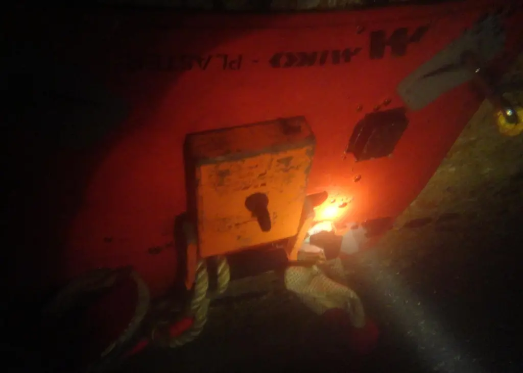 A diver’s torch shows the patch and magnet sealing