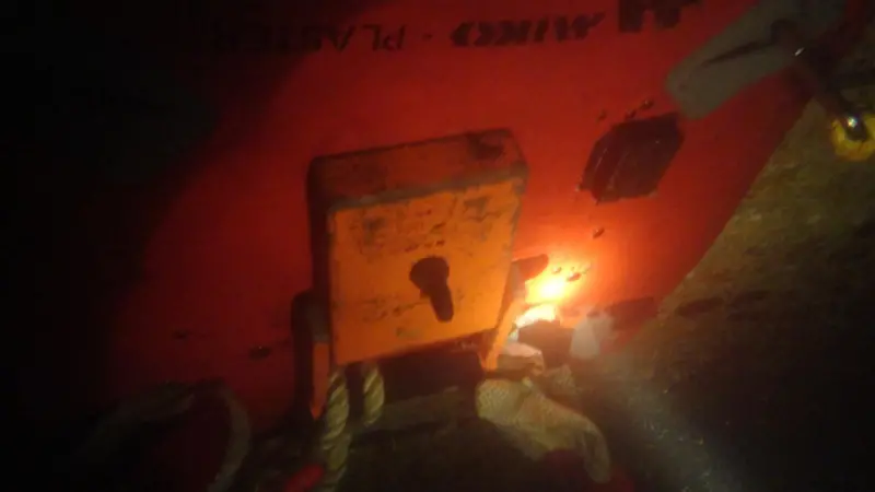 A diver’s torch shows the patch and magnet sealing