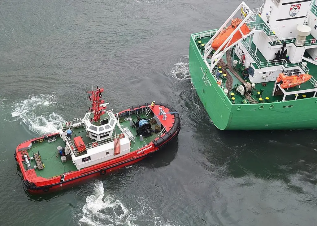 The SMS tug Irishman assists Arklow Meadow in the Port of Belfast. Photo courtesy of Alan Geddes
