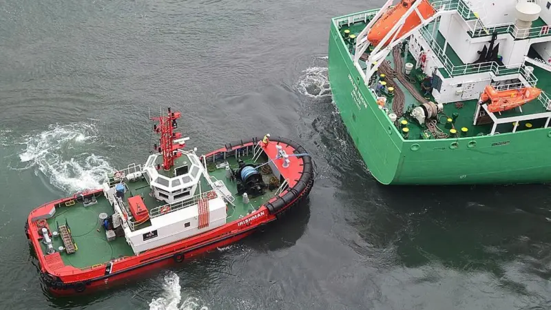 The SMS tug Irishman assists Arklow Meadow in the Port of Belfast. Photo courtesy of Alan Geddes