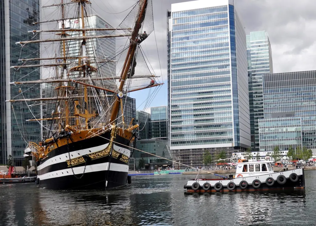 The tug/workboat Devious is seen swinging the Italian training ship Amerigo Vespucci in London Docklands