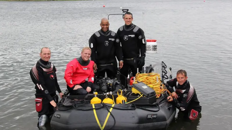 Alan Nicholls (in boat standing left) with members of the Norfolk USWAR team
