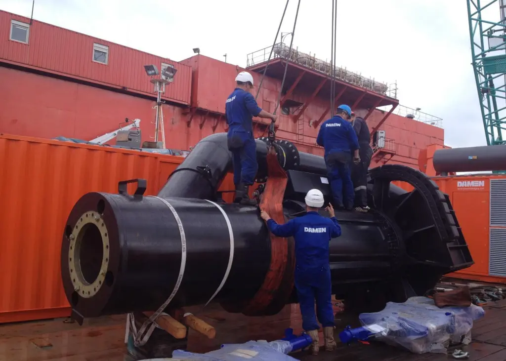Damen field service engineers at work on the submerged dredge pump, which is integrated in the trailing pipe