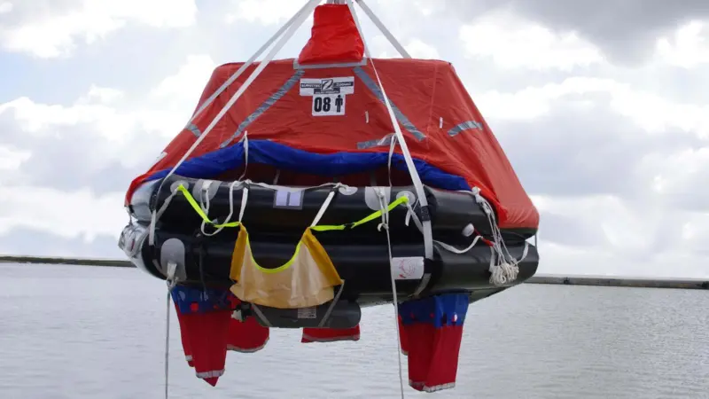 In an emergency the container is connected to a davit and swung outboard where it is inflated and boarded