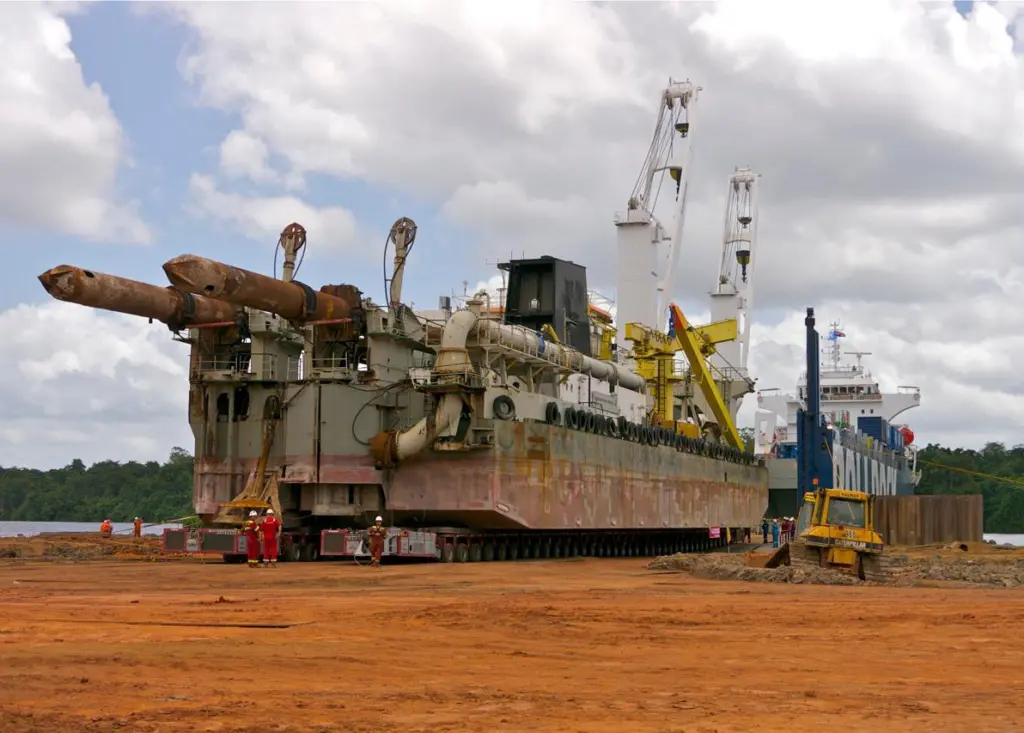 ‘Rolldock Sea’ beginning offload of the dredger onto the prepared ramp, Paranam