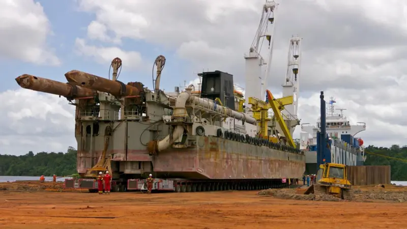 ‘Rolldock Sea’ beginning offload of the dredger onto the prepared ramp, Paranam