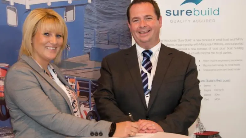 Sharon Mainprize from Mainprize Offshore and Nick Warren, managing director of Burgess Marine, sign the paperwork at Seawork 2015