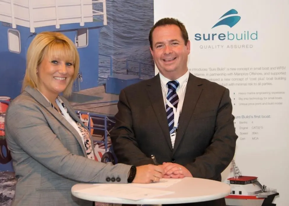 Sharon Mainprize from Mainprize Offshore and Nick Warren, managing director of Burgess Marine, sign the paperwork at Seawork 2015