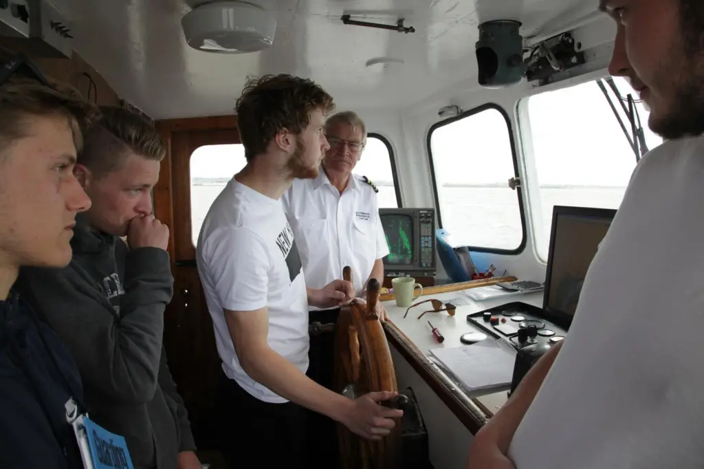 John Potter instructs apprentices on the bridge of his vessel. Photo (c) G Ewens