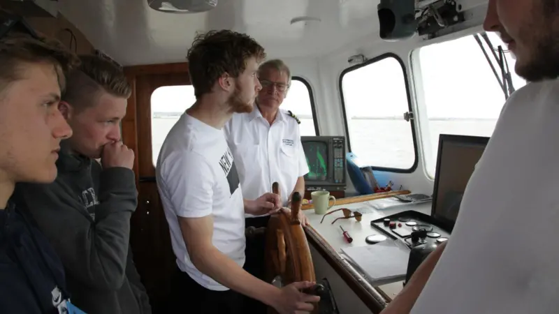John Potter instructs apprentices on the bridge of his vessel. Photo (c) G Ewens