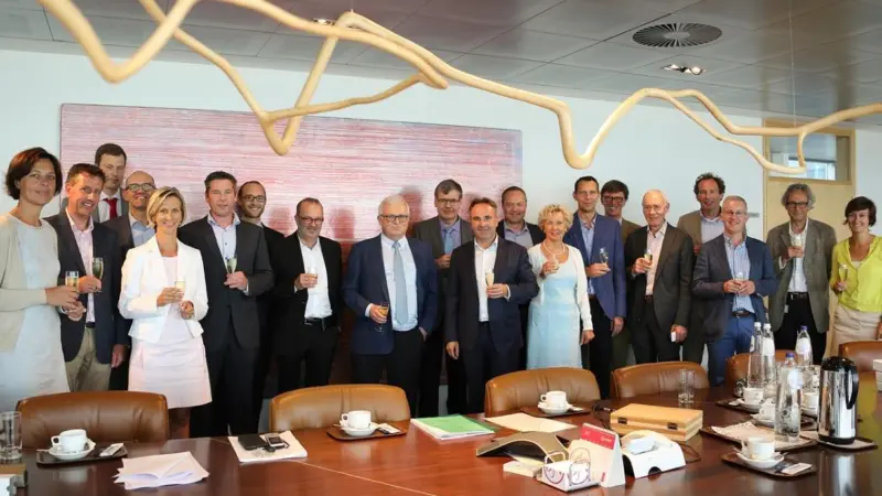 Employees of Jan de Nul NV and Algemene Ondernemingen Soetaert NV celebrate