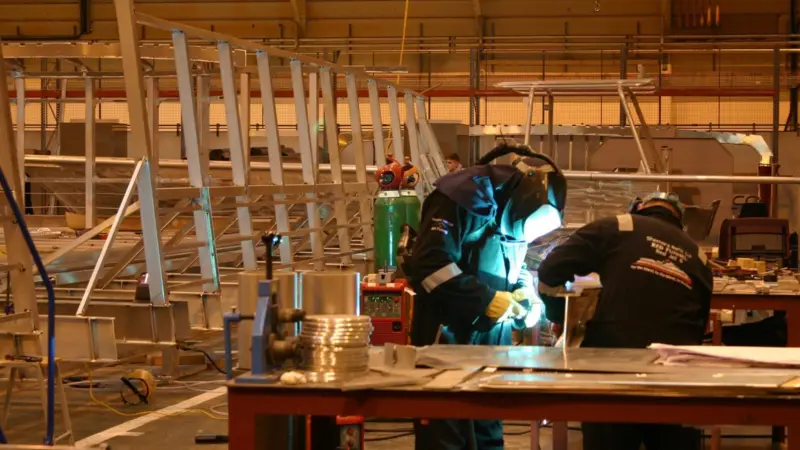 Workers beginning to weld up deck beams for 'RedJet 6'