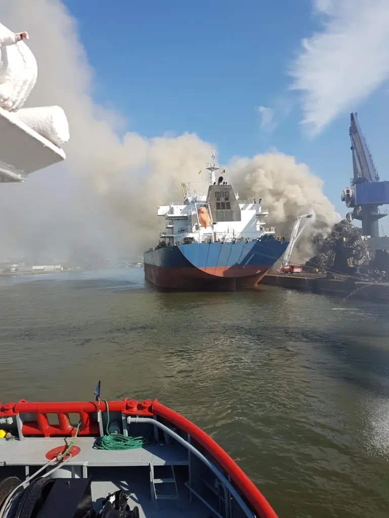 The tugs shifted a bulk carrier moored at the facility to a safe berthing place away from the blaze