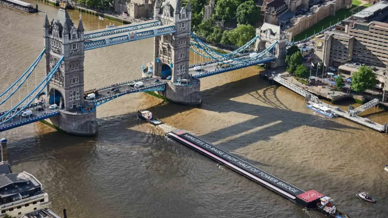 Livett's tugs guide the barge through  London's Tower Bridge (Livett's Group)