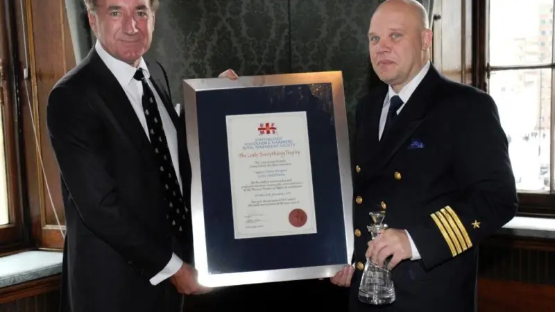 Captain Patrik Norrga°rd (left) of the P&O Ferry, 'MV Norstream' accepts his award
