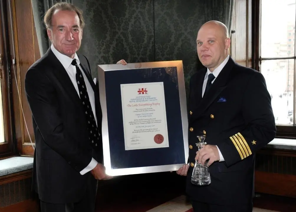Captain Patrik Norrga°rd (left) of the P&O Ferry, 'MV Norstream' accepts his award