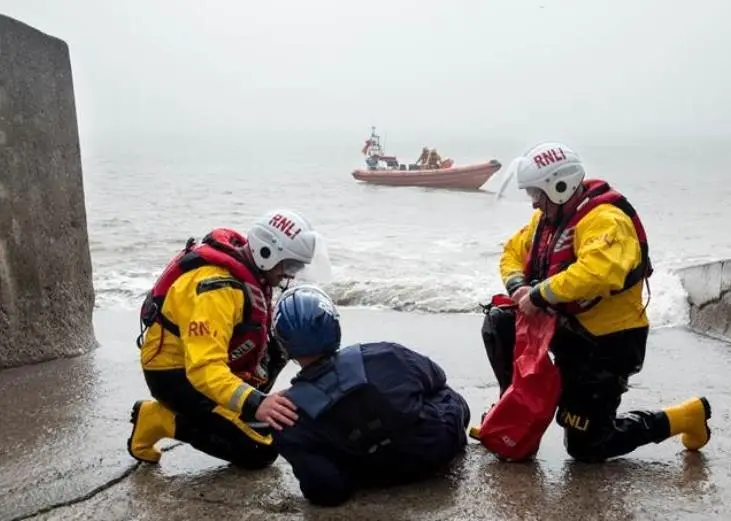 Crew members giving casualty care to a mock casualty during an exercise featuring a drone (Photo: RNLI/ Nathan Williams)