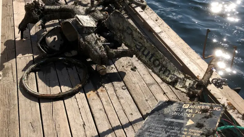 Harbour signs, a tangle of bikes and a moped are pulled from beneath Oslo's pristine surface. Photo: Oslo Havn