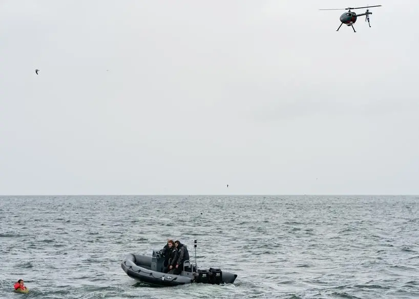 Delft Dynamics RH3 drone (RH-3 Swift), hovers above a fast rescue boat and casualty