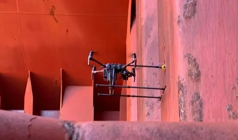Airborne drone conducting ultrasonic thickness measurements inside the hold of a bulk carrier