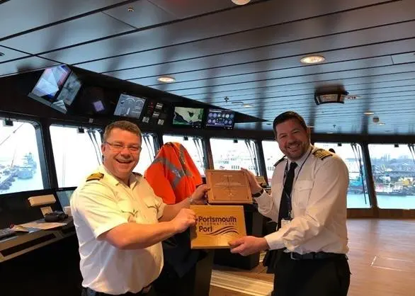 Captain (left) and Harbour Master exchange plaques for the first visit of 'Fridtjof Nansen'