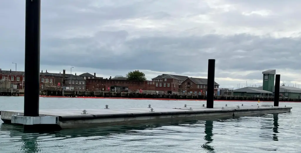Concrete breakwater units installed in position looking towards HMS Dolphin