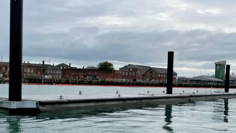 Concrete breakwater units installed in position looking towards HMS Dolphin