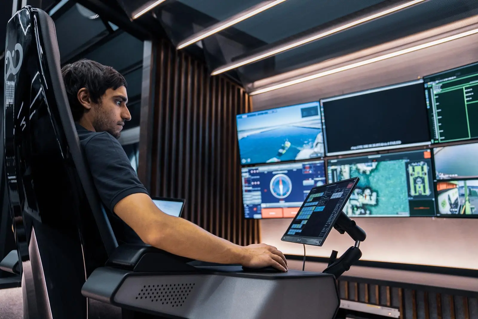 One of the pods set around a cavernous room at the RCC - A person controlling a vessel remotely, with several screens in front