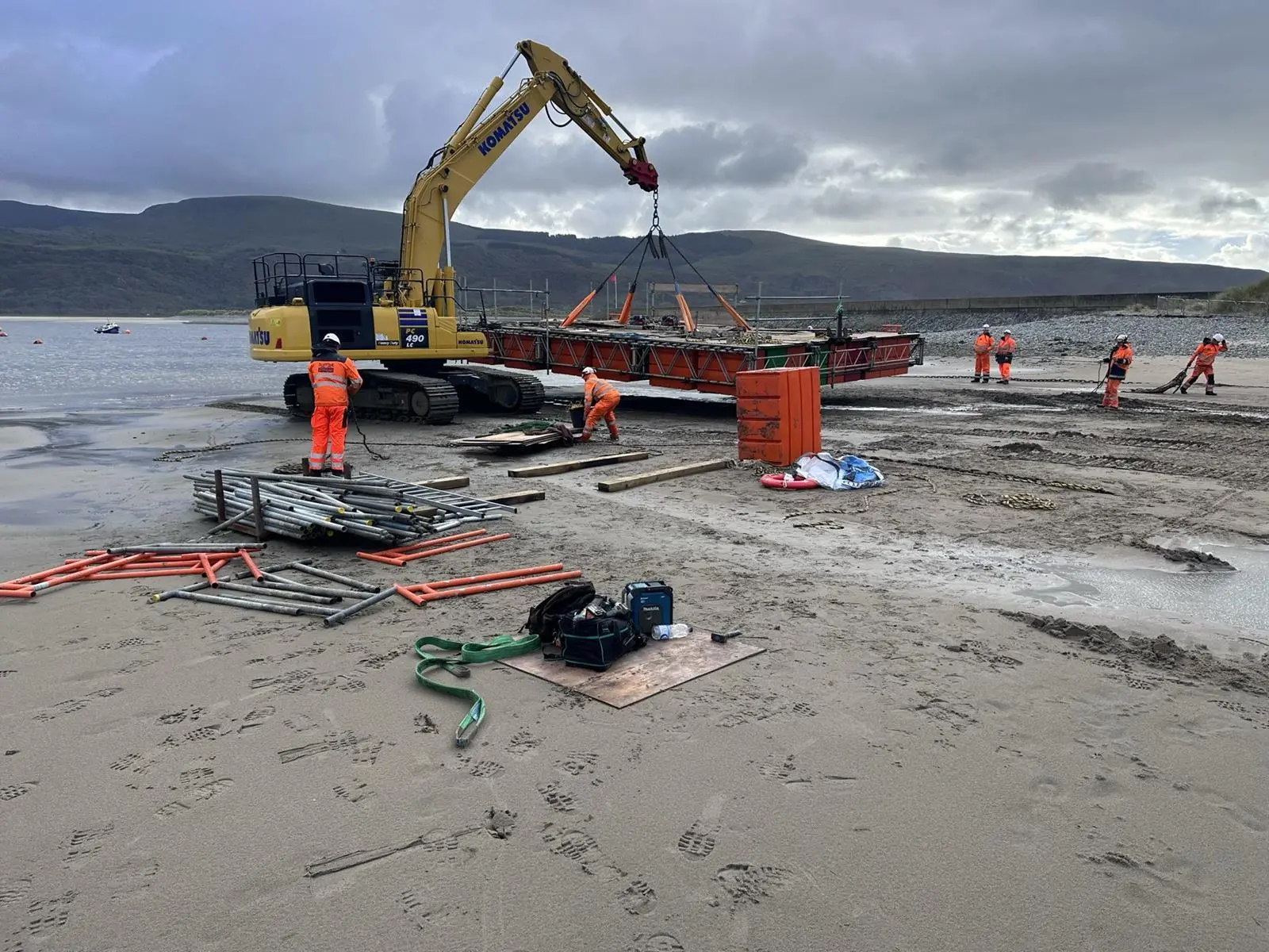 Tracked excavators used for the demolition were also used to carry the pontoons down the beach, where they could be floated on the tide