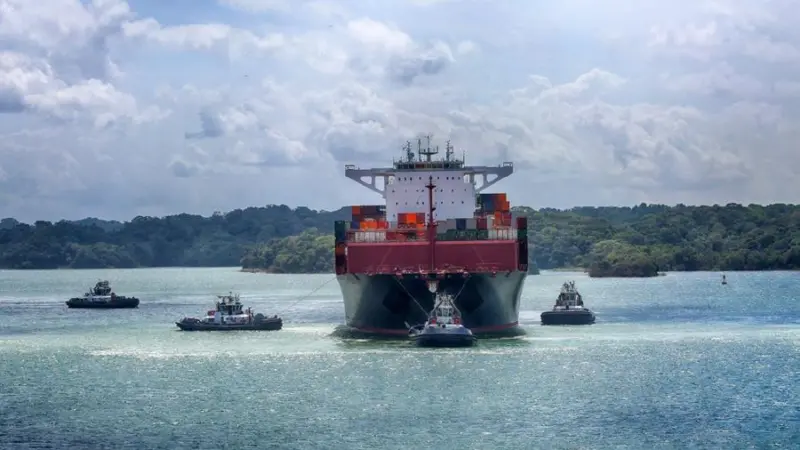 Container ship and tugs near the Panama Canal