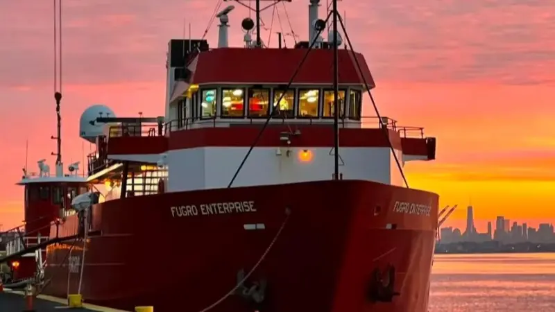 An image of the Fugro Enterprise survey vessel at dock at sunset