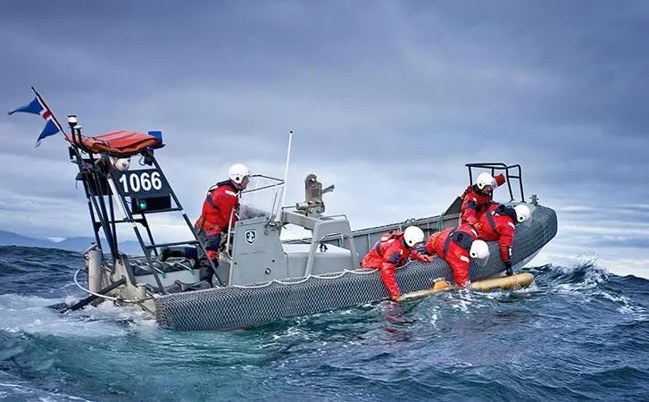 The image shows a team at sea deploying a Teledyne Gavia AUV